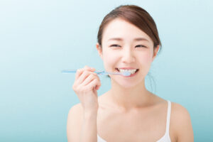 笑顔で歯磨きをする女性