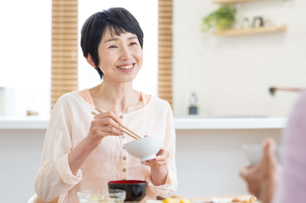 奥歯をセラミックにして快適に食事をする女性
